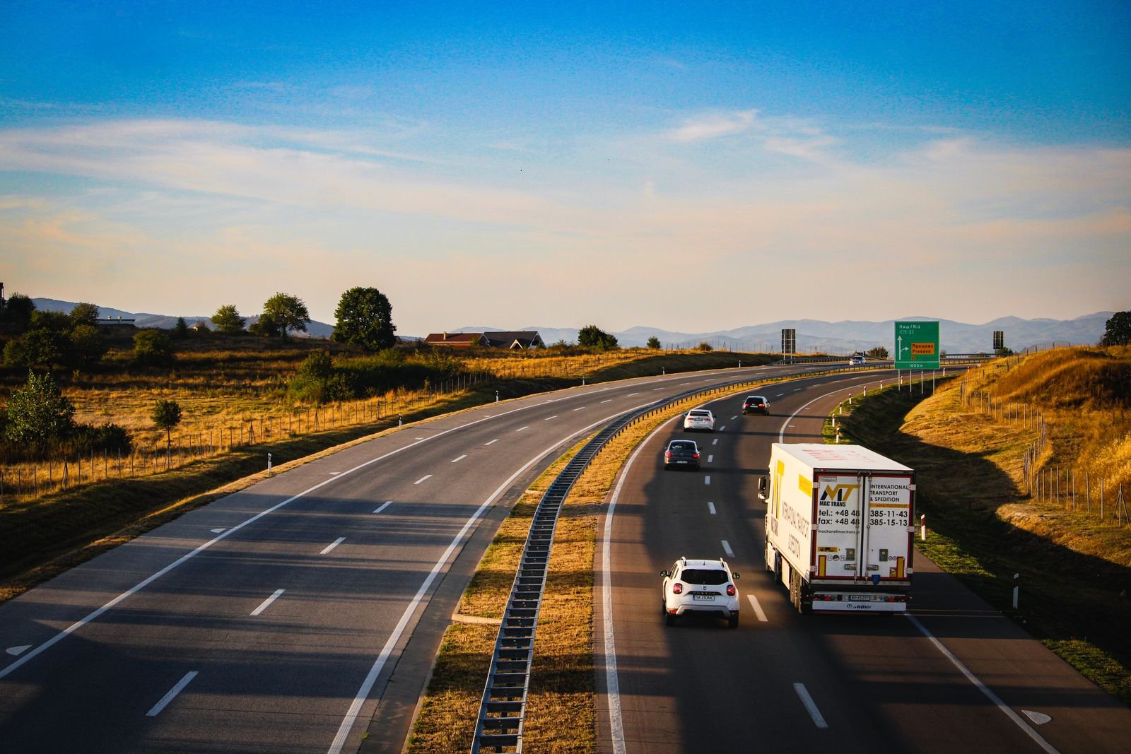 Scenic highway with vehicles in motion during golden hour